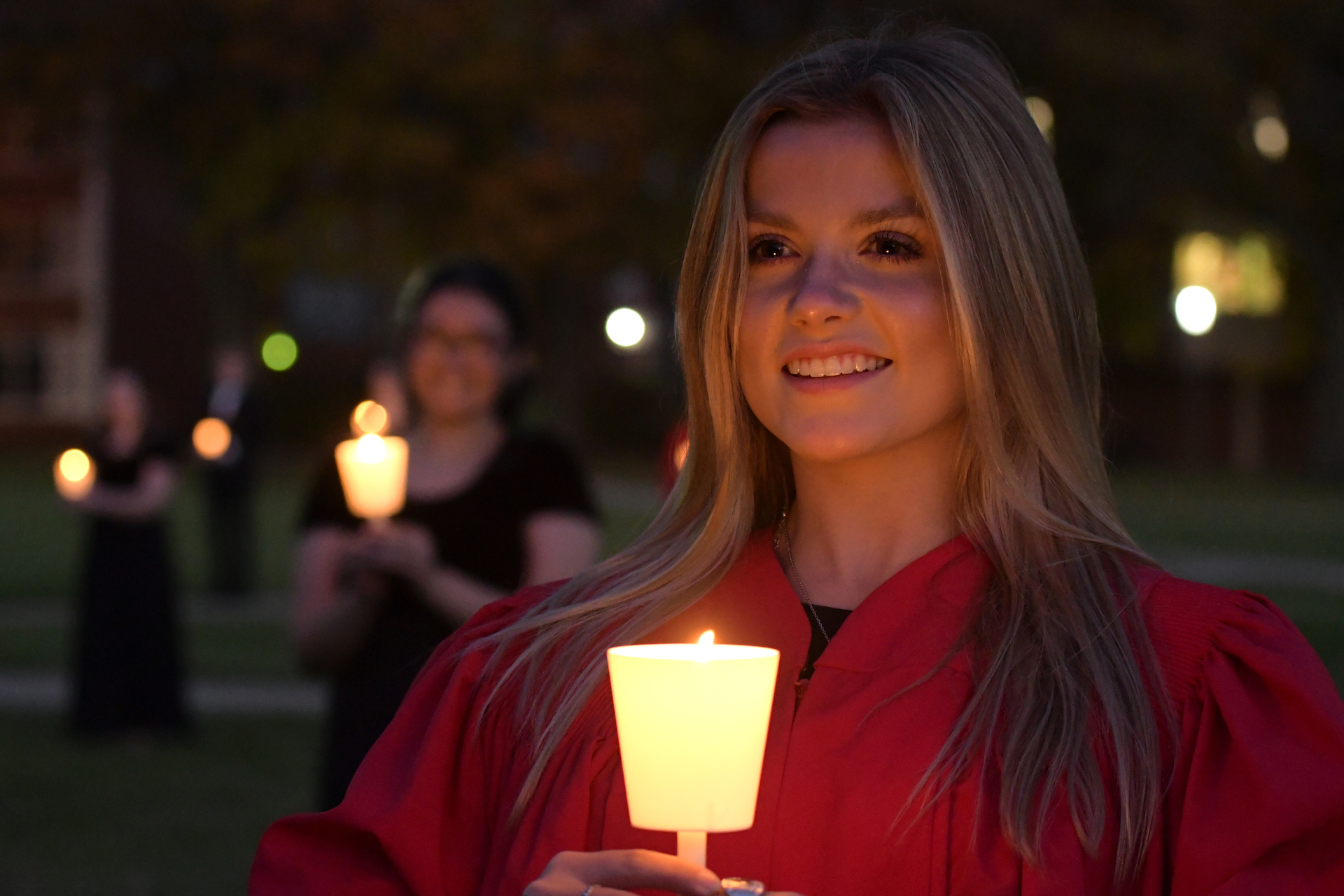 Female student holding candle