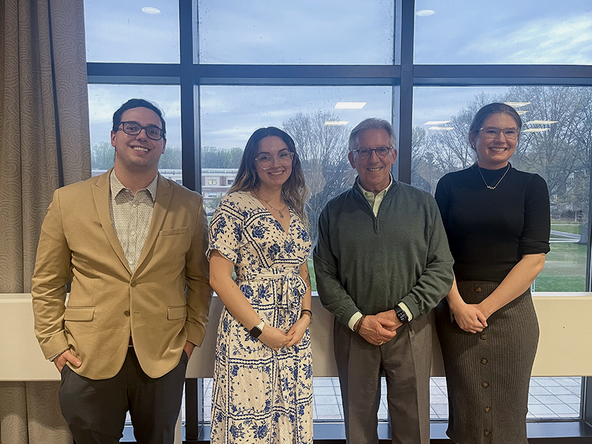 Three Koppelman Scholars pose for photo with University President.