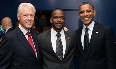 Image of Gregory Lorjuste with Bill Clinton and President Ob