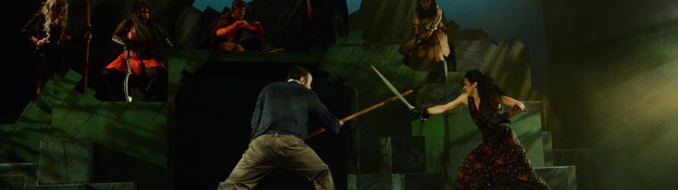 Man and Woman sword fighting in the Play "She Kills Monsters