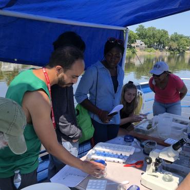 STEM institute students run experiment on boat