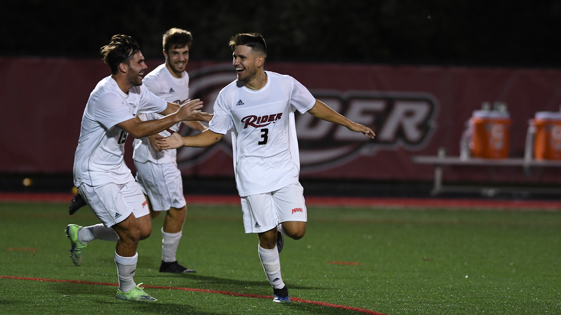 Men's soccer players celebrate