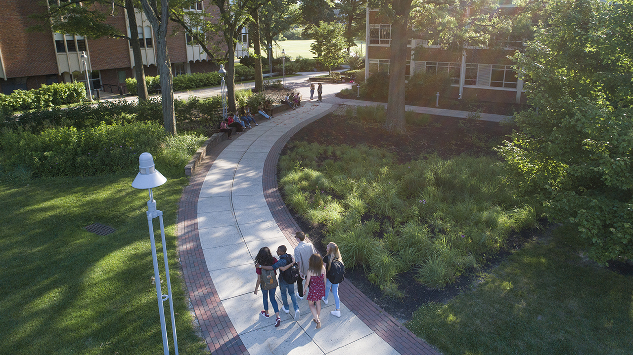 A group of students walking across campus