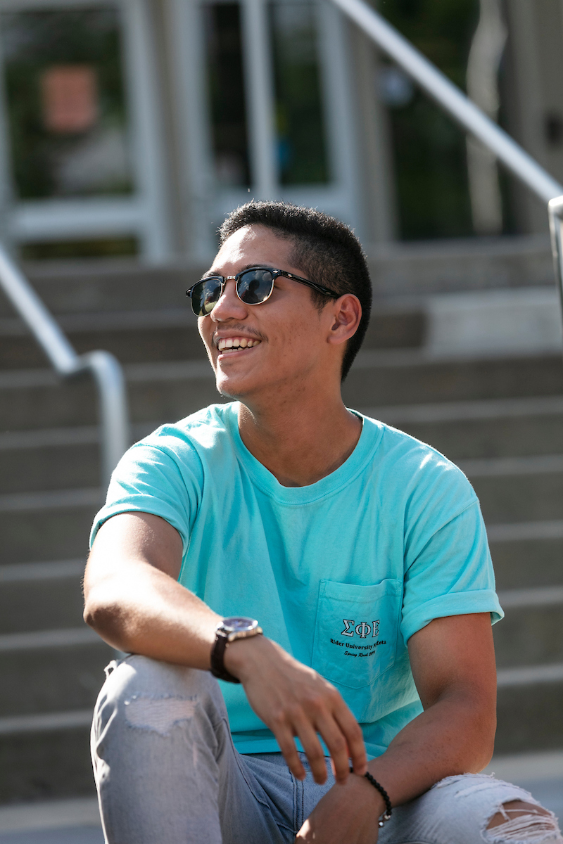 Student smiles on library steps