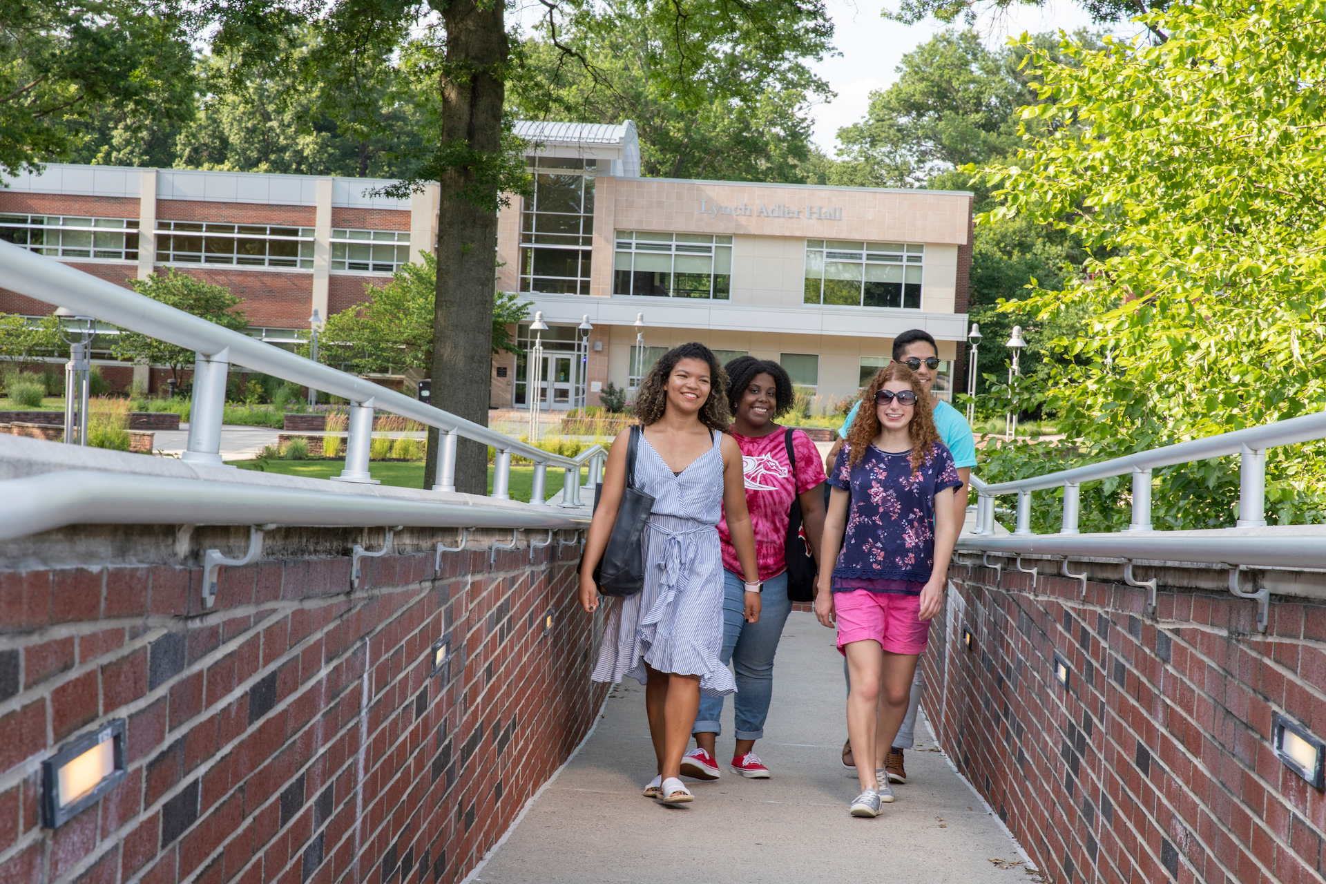 Students walk across campus in spring