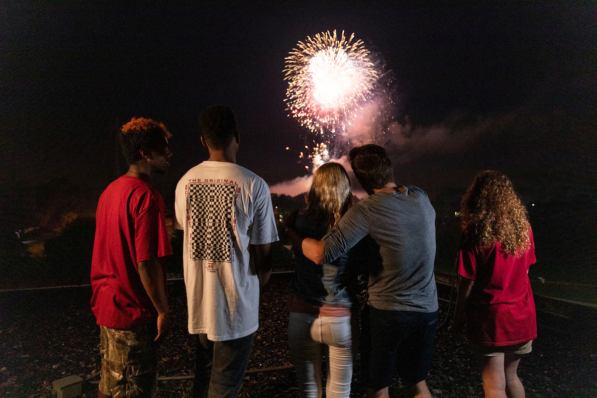 Group of students watch fireworks together.