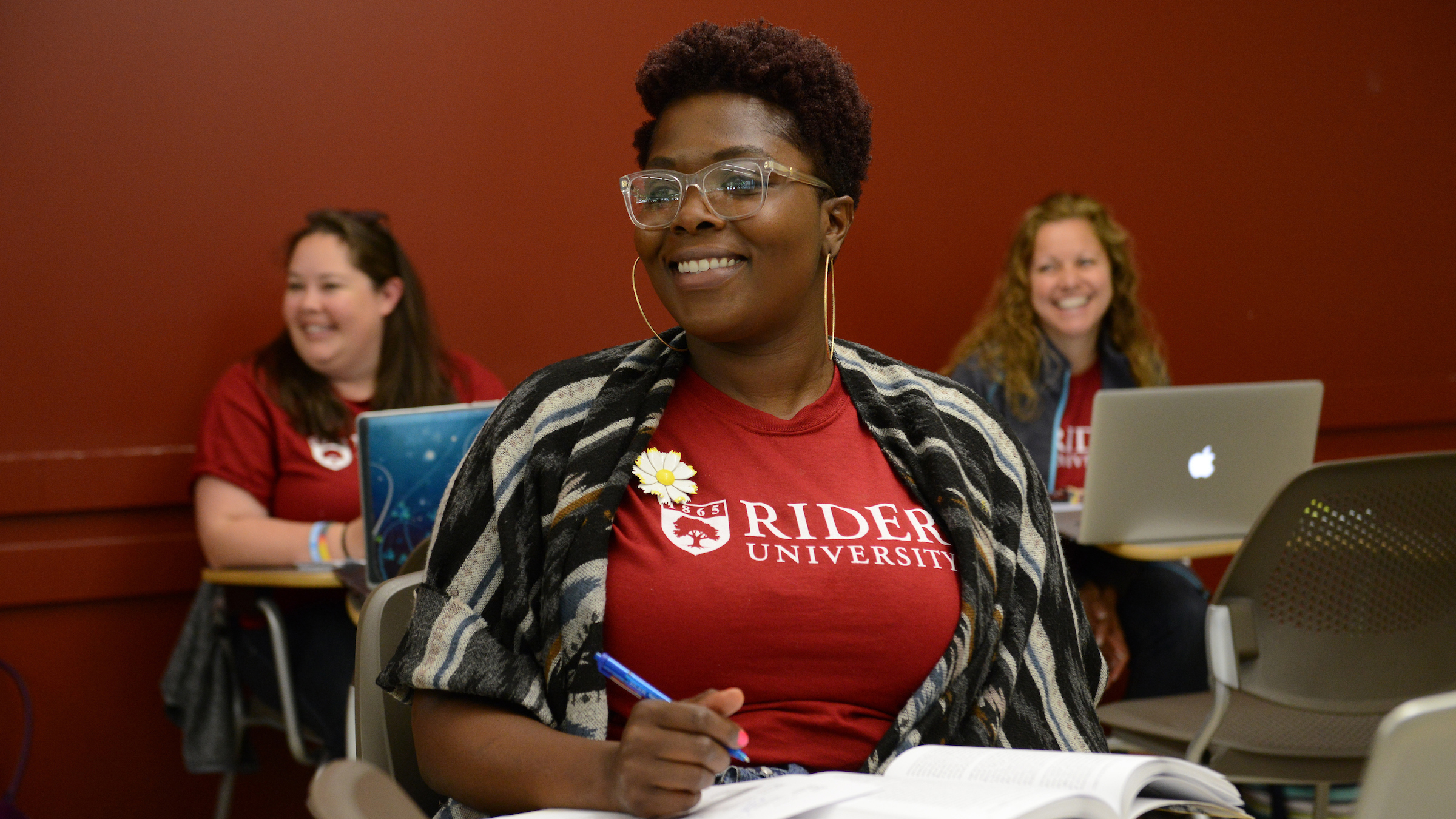 Doctoral student takes notes in class