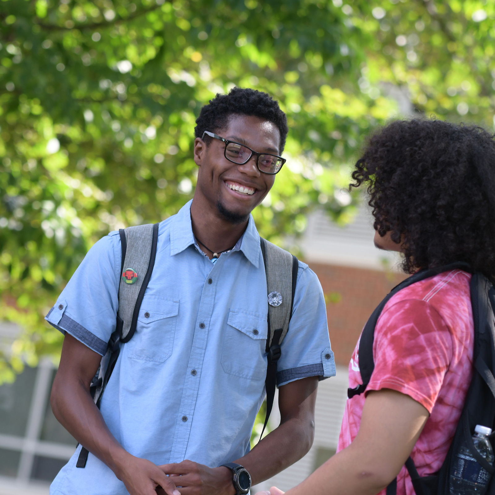 Two students talk with each other