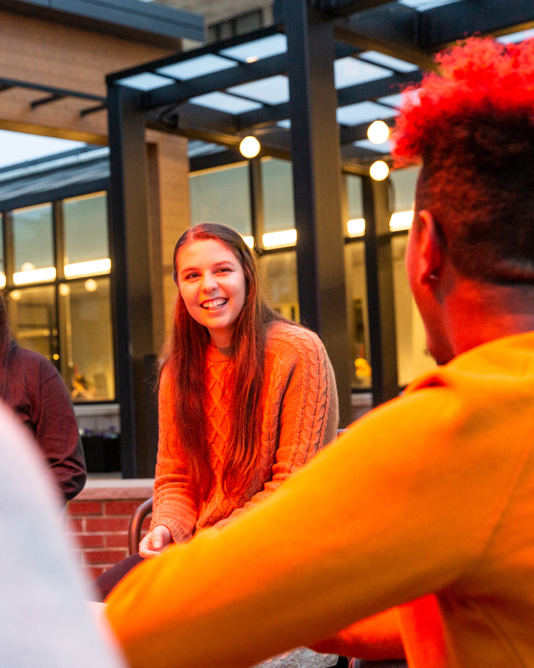 Students talk near fire pit