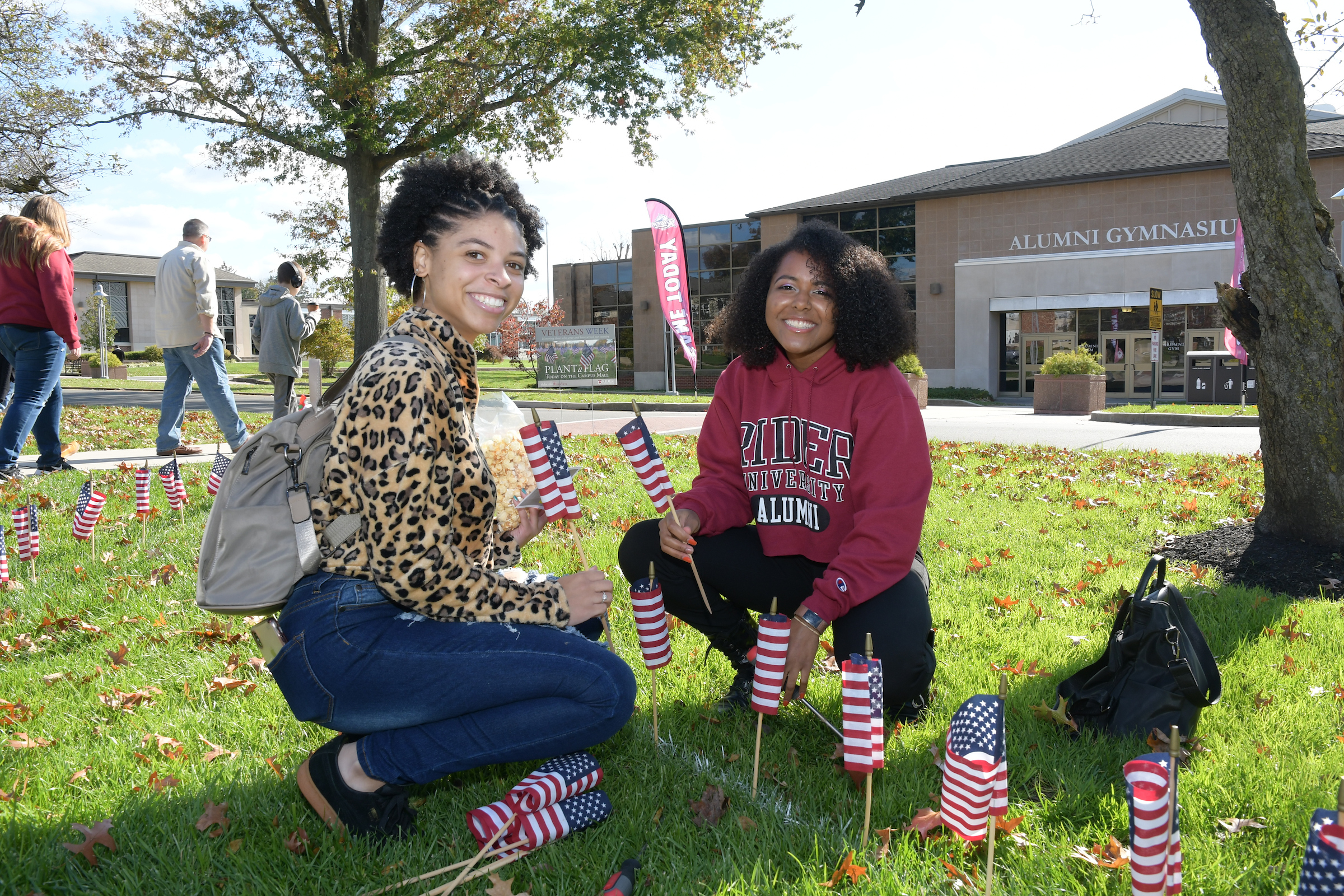 Alumni plant flags during Family Weekend