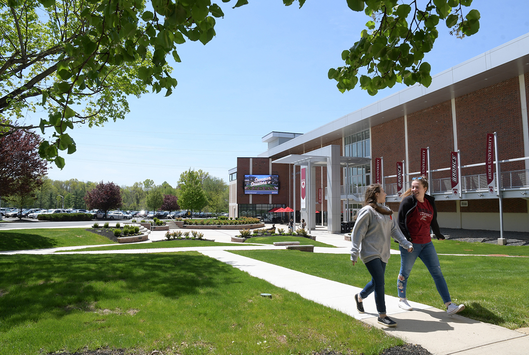 Students walk in front of Bart Luedeke Center