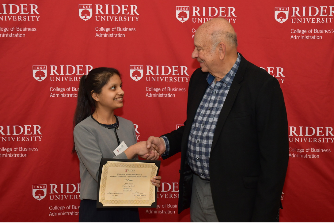 Norm Brodsky congratulates scholarship recipient