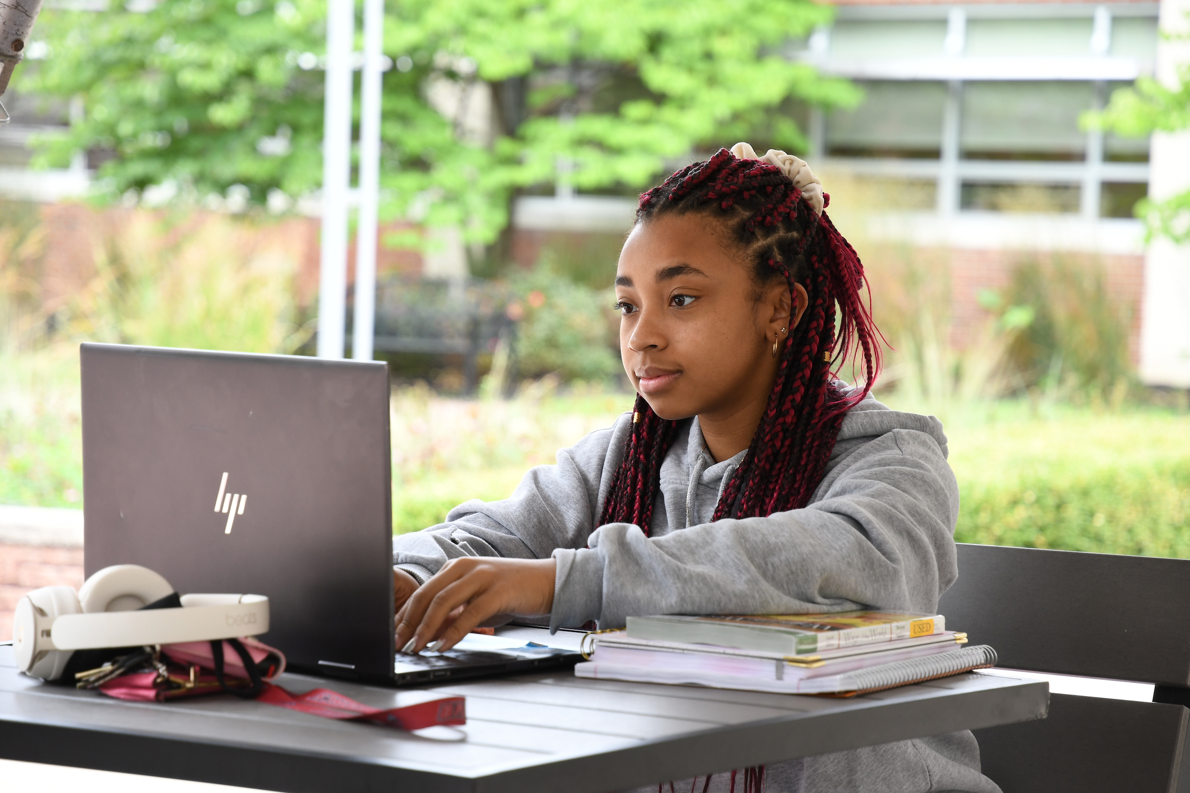 Student working outside on laptop 