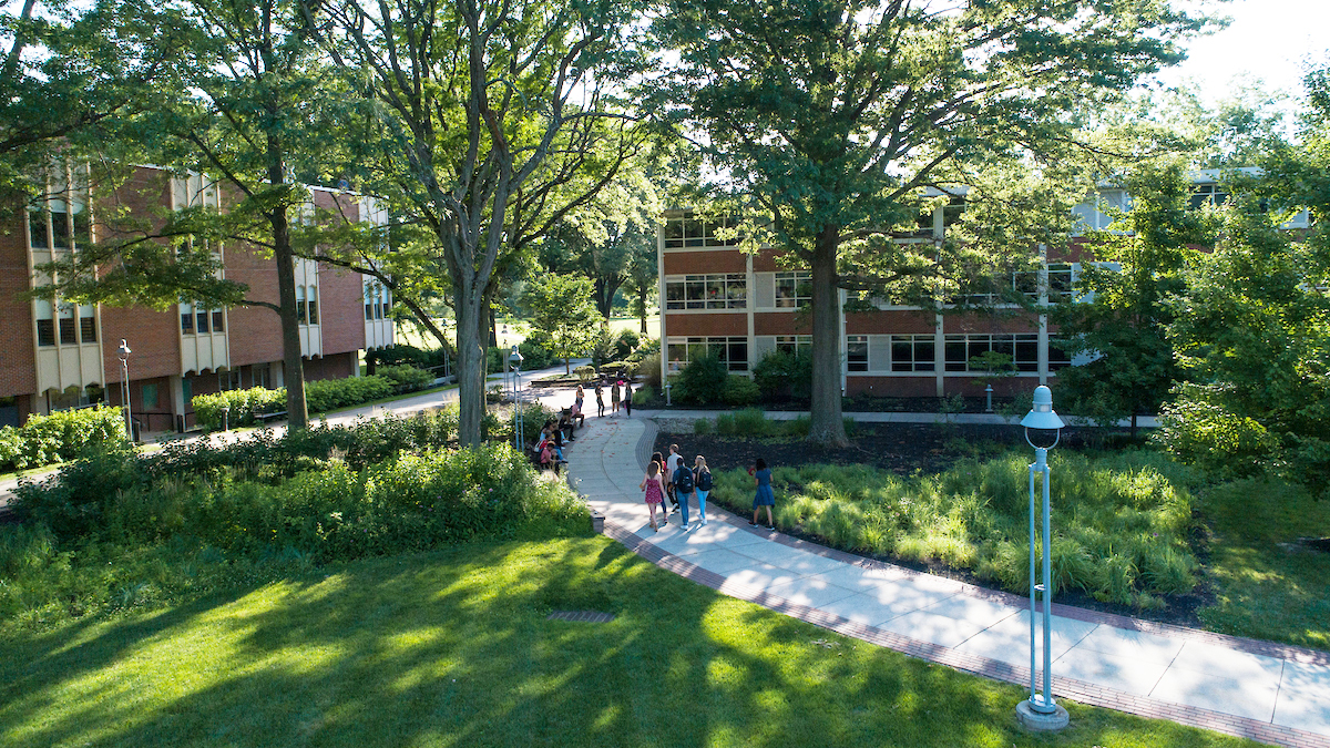 Students walk across academic quad