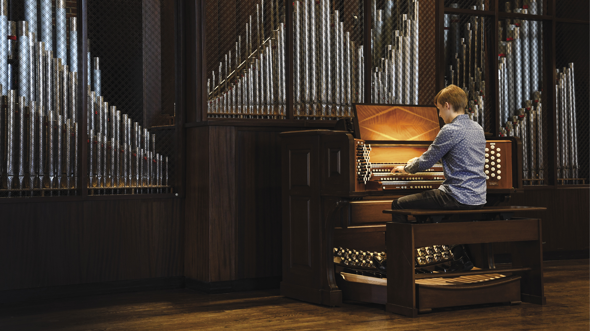 Student playing organ in Gill Chapel