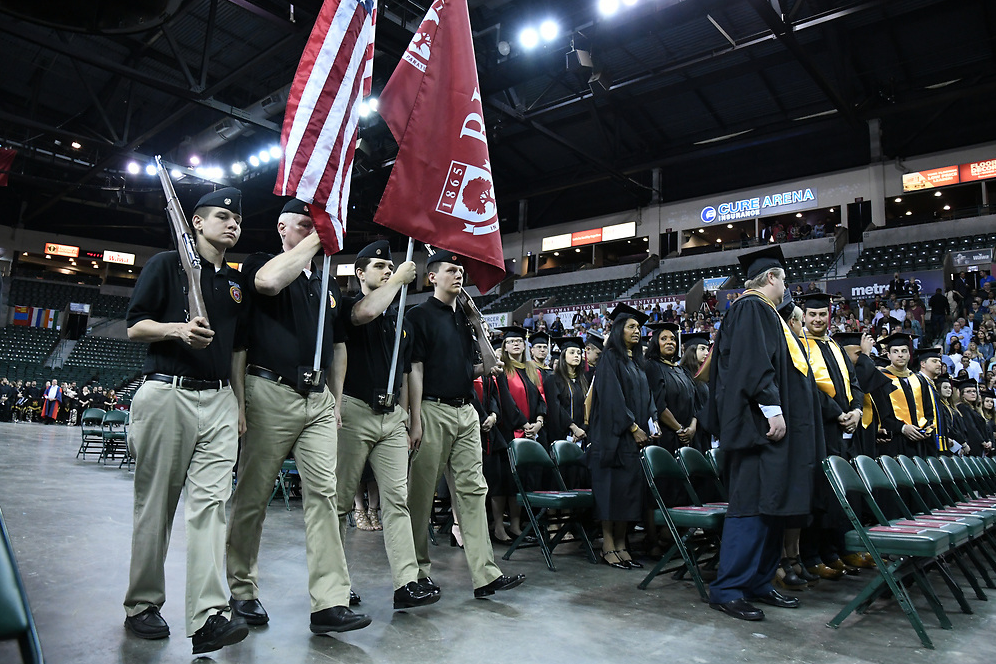 Color Guard carries flags at Rider Commencement