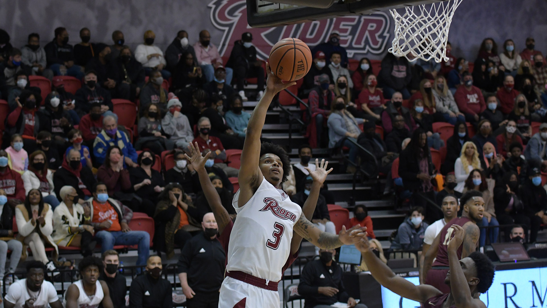 Men's basketball player goes for a layup