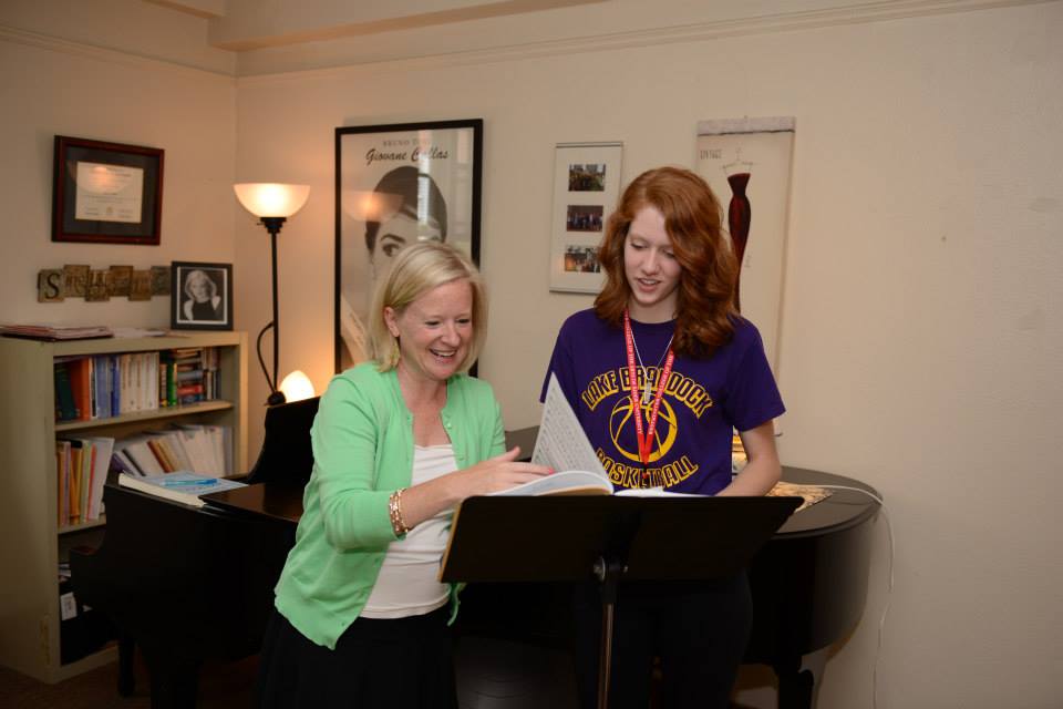 Faculty member teaches voice student.