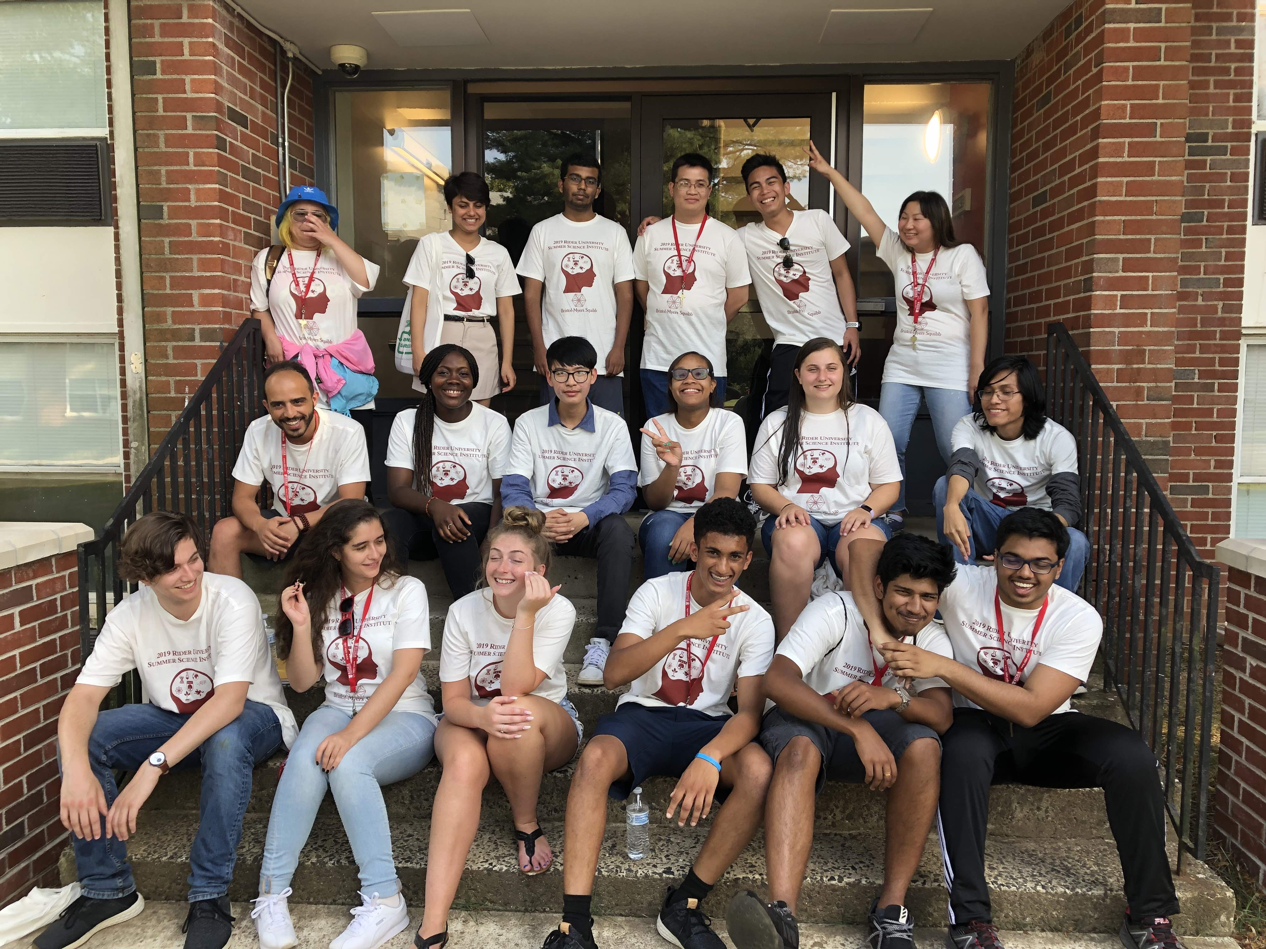 Students in the STEM institute take group photo on stairs