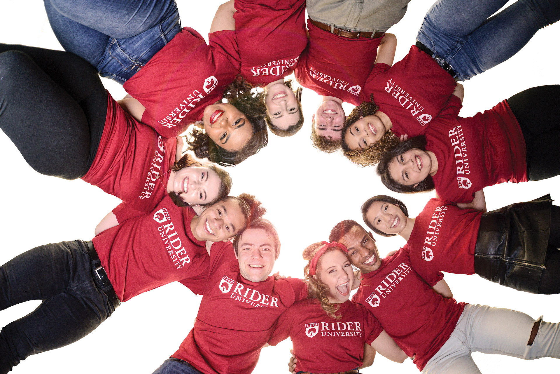 Student stand in a circle and smile for camera