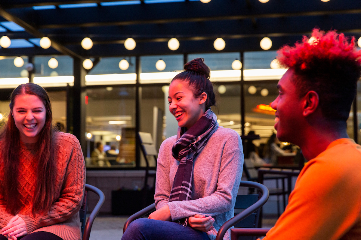 Students laugh together on BLC patio