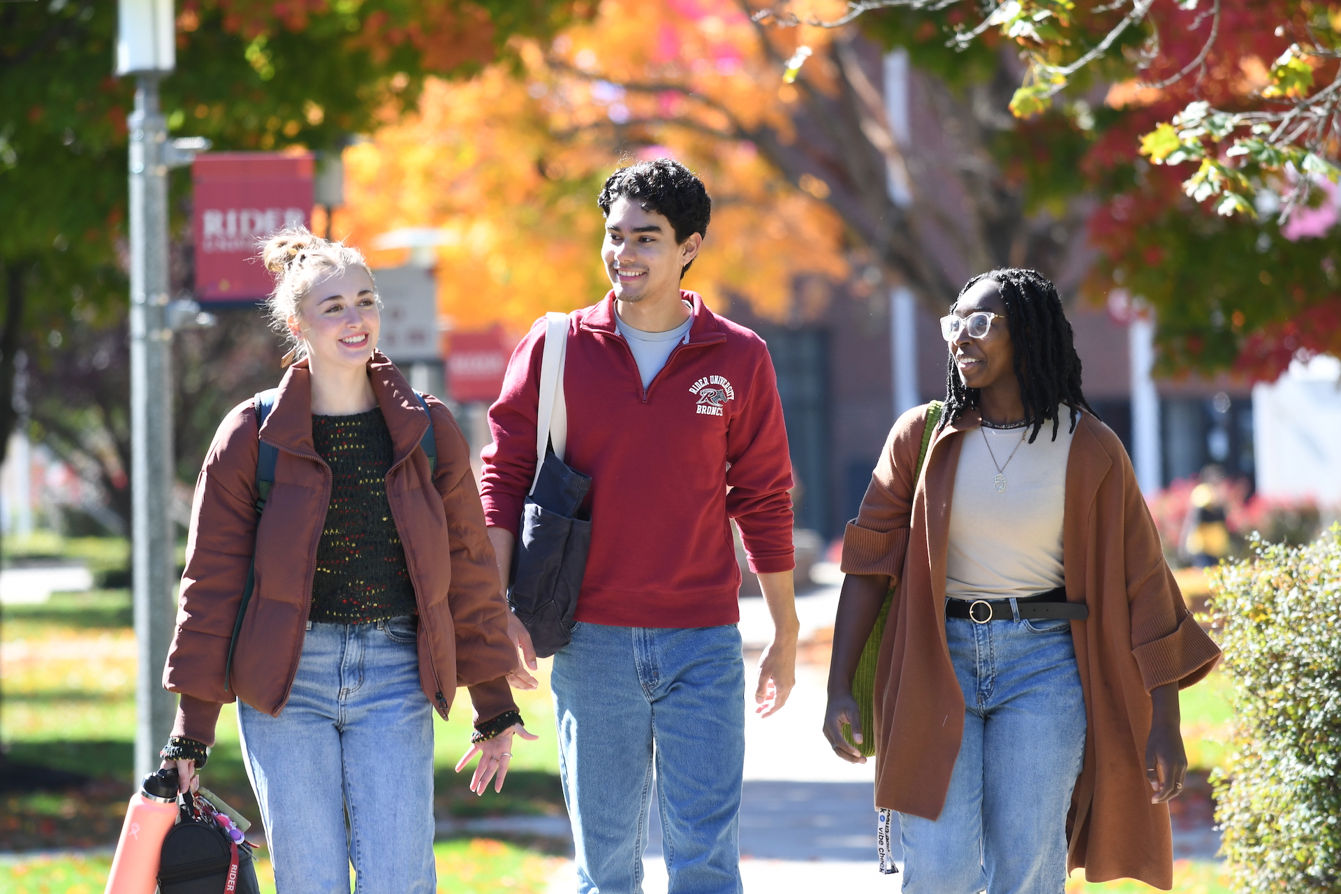 Students walking campus in the fall