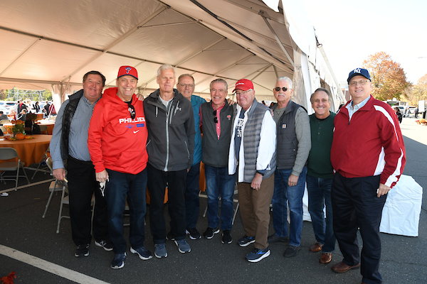 Group of alumni pose at Homecoming event