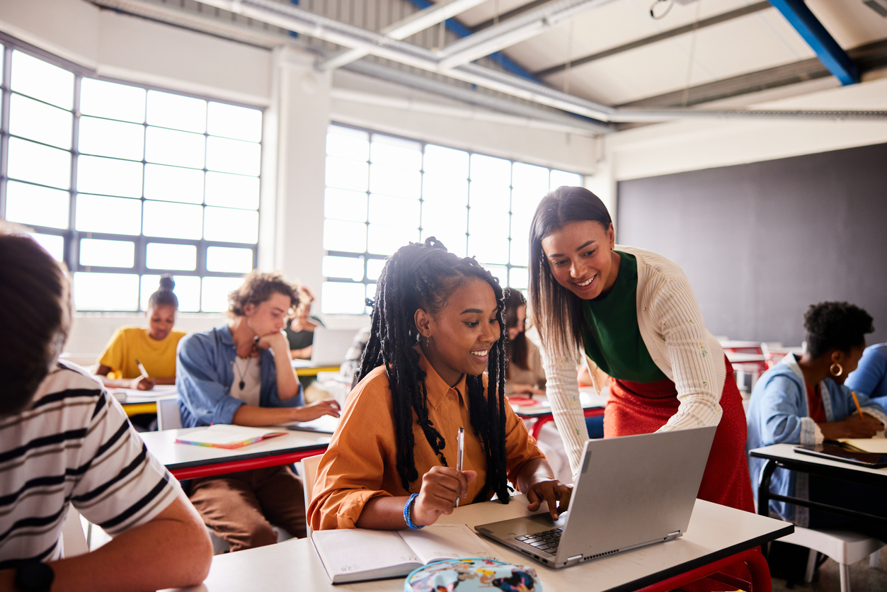 Teacher helps student with a class assignment