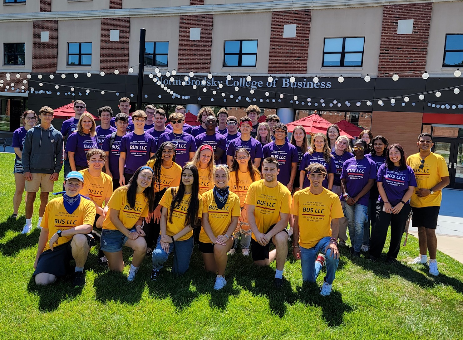 Students in the Business Living and Learning Community gather outside. 