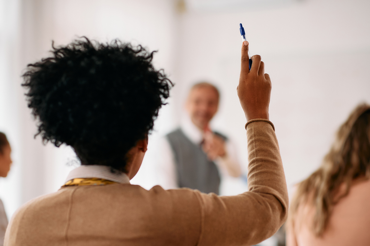 Student raising arm in classroom