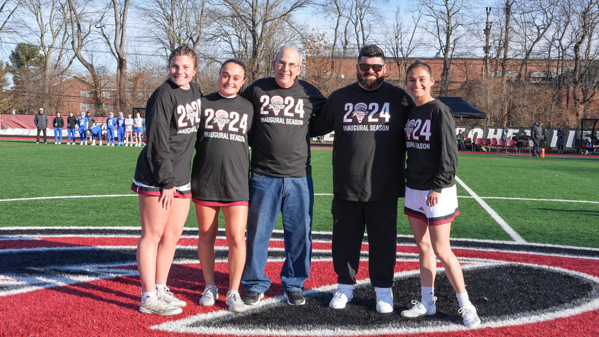 Alan Gurwitz poses with Rider lacrosse players and coach