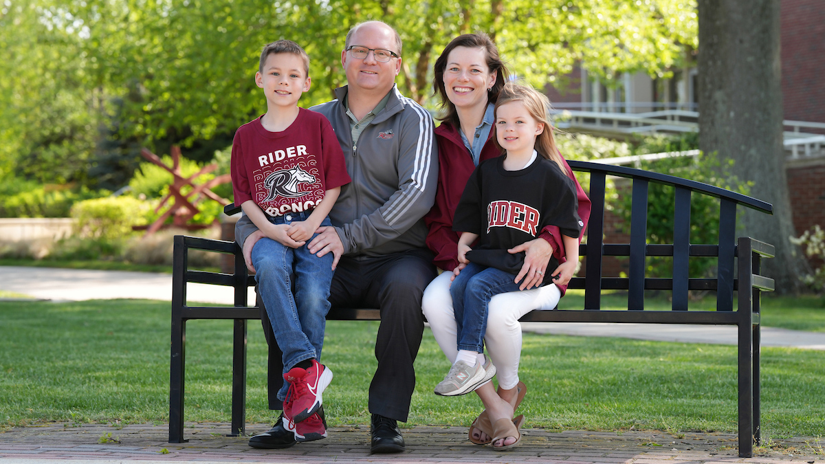 Lucas family sitting on bench near library