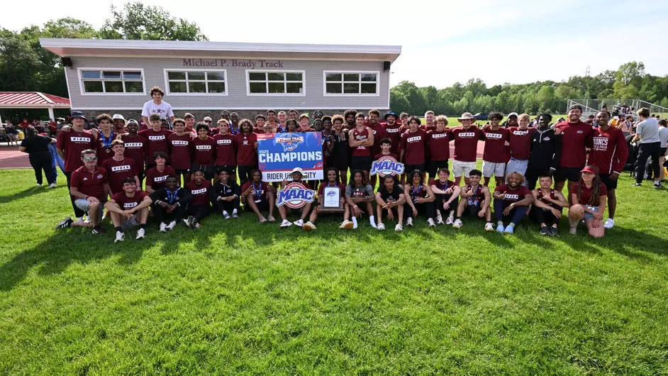Men's track and field posing after win