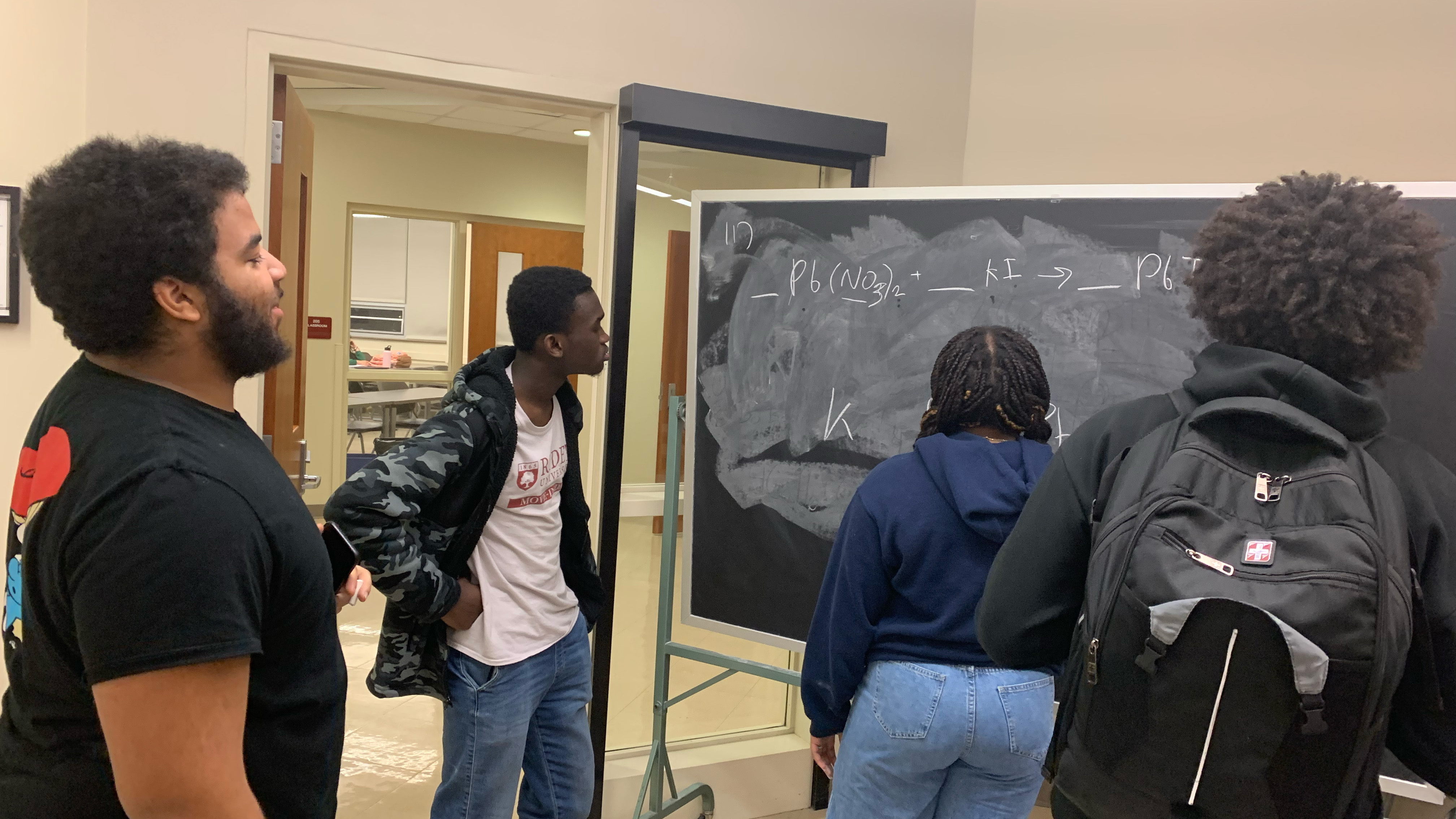 Students writing on chalk board
