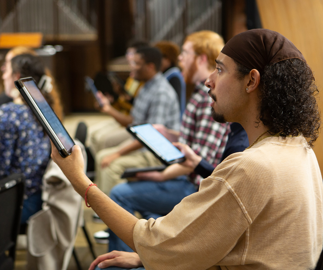 music students in class holding ipads