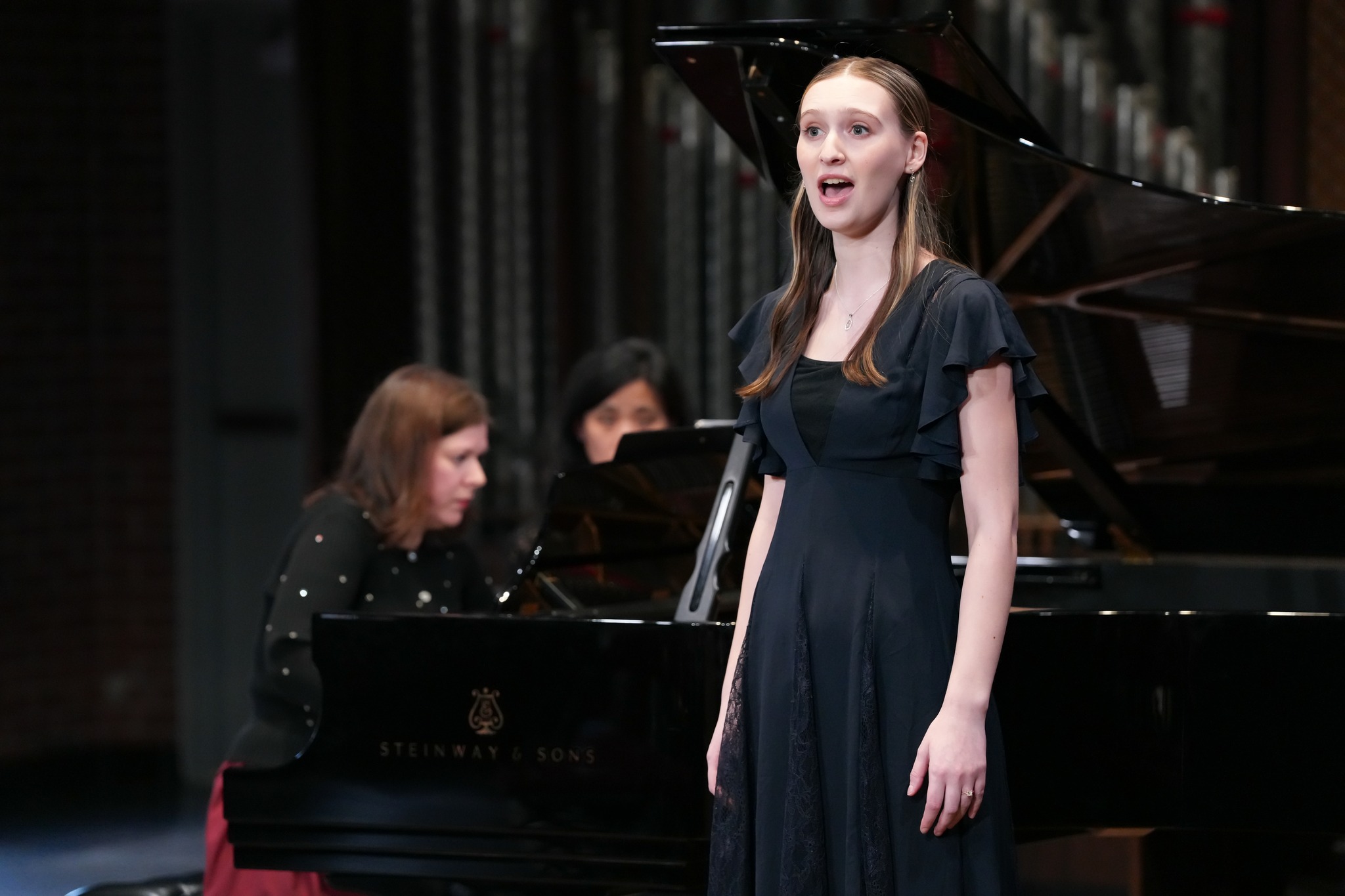 Student in a singing performance with piano accompaniment