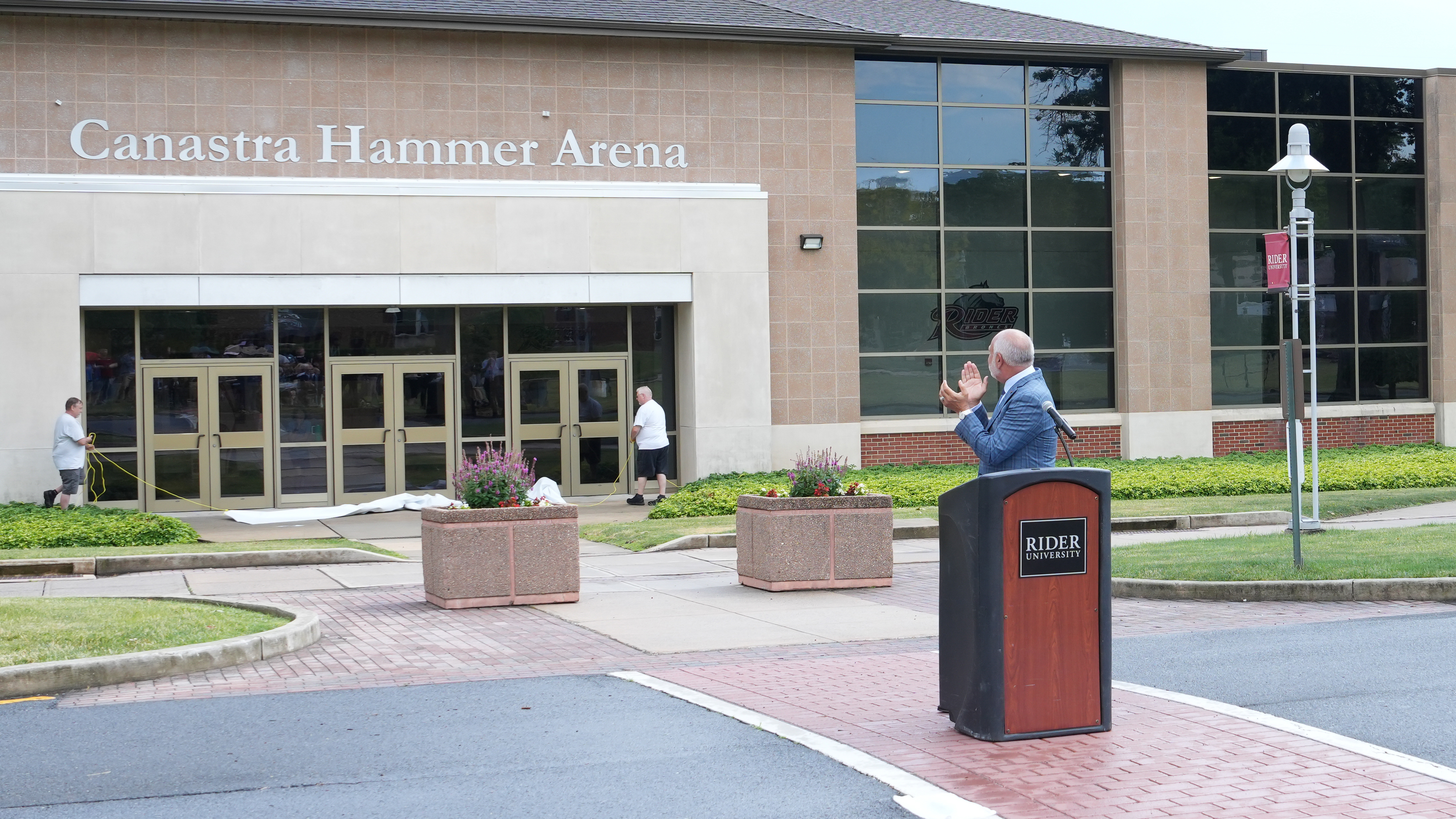 President John R Loyack applauds in front of Canastra Hammer Arena