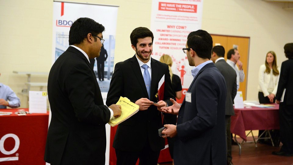 Three students at a career fair event.