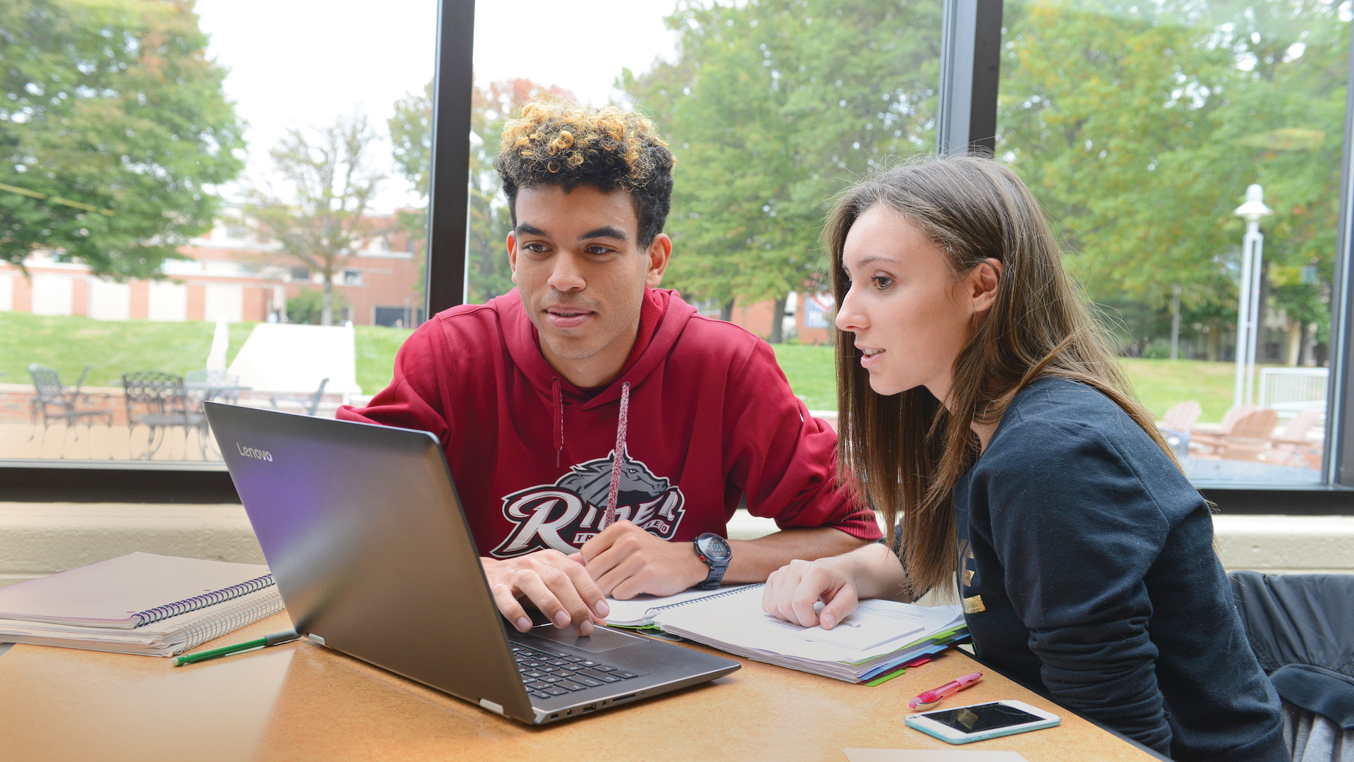 Two students use laptop