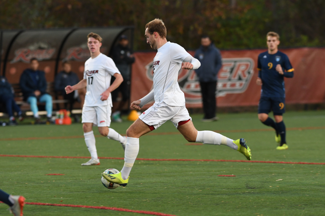 Soccer player kicks soccer ball.