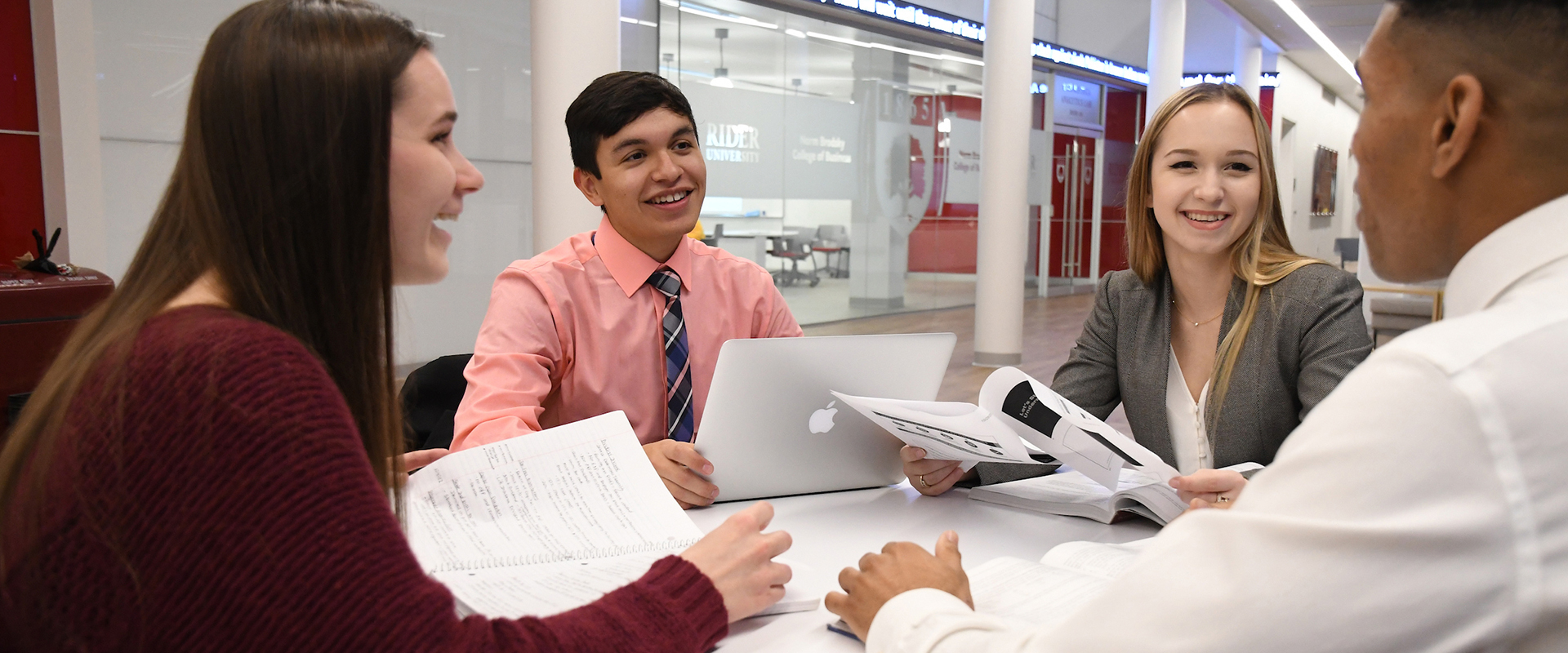 AccountingDept_Hero_1920x800.jpg Students sit in around table laughing.
