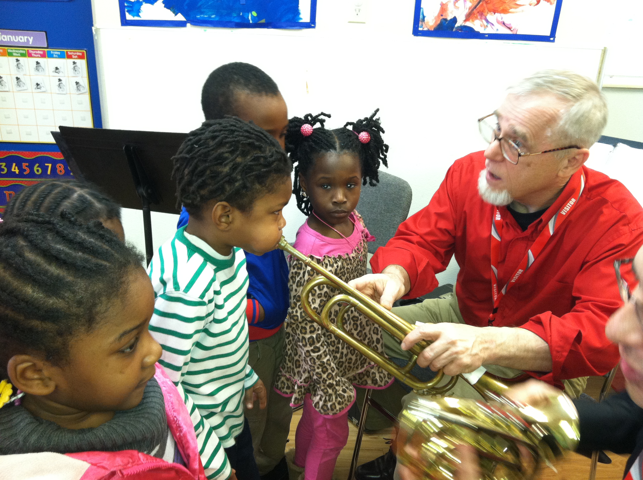 Westminster faculty holds instrument in classroom with young students.