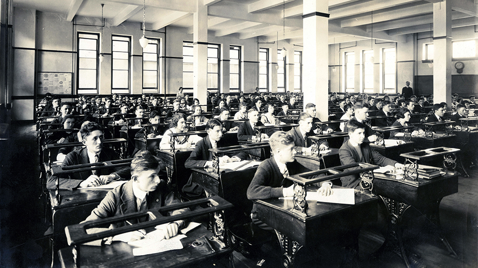 Male_and_female_students_seated_at_desks_in_classroom.jpg