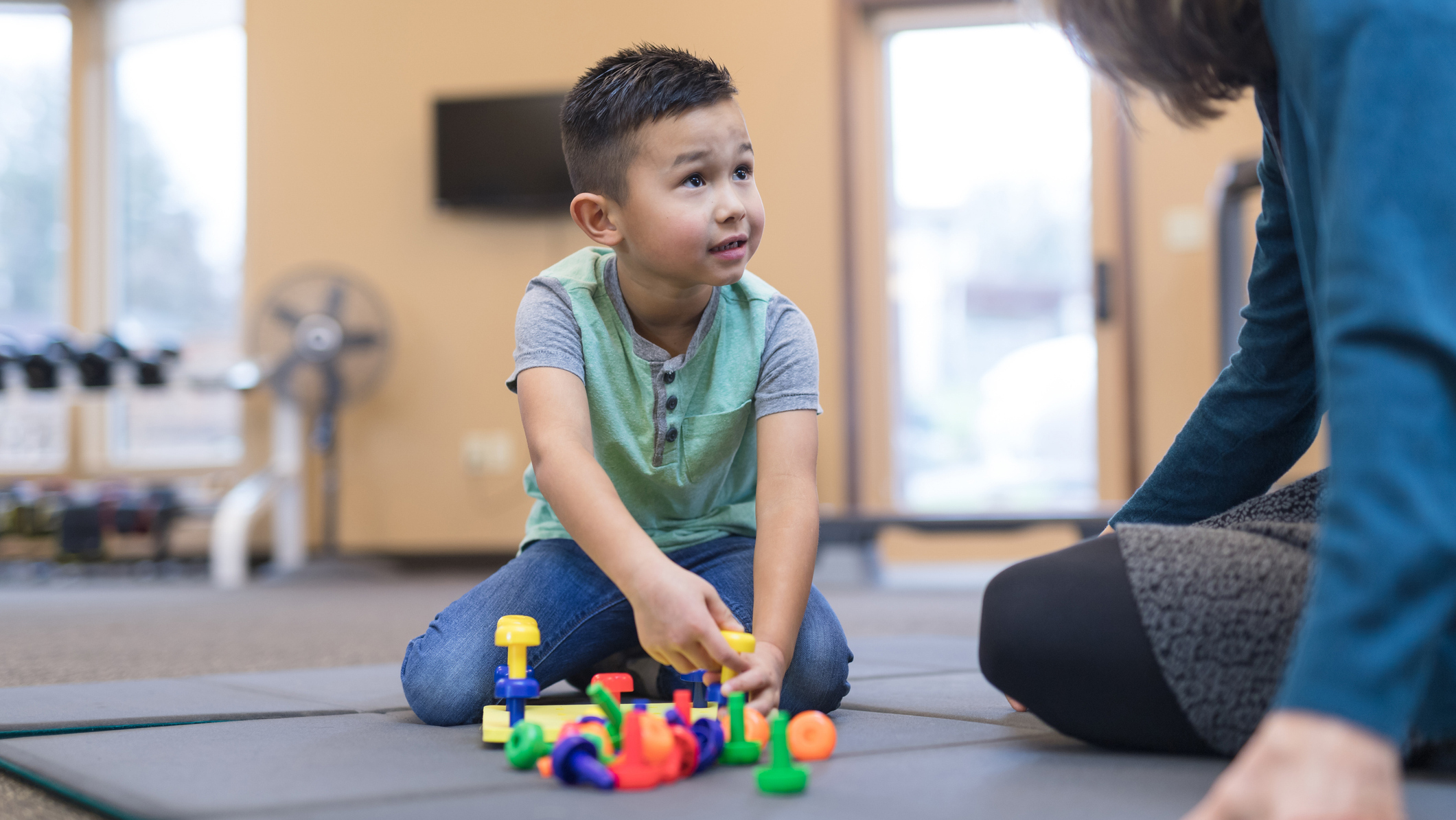 Child plays with toys with supervision