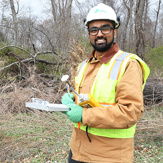 Muhammad Y. Sarwar holds gear outside.