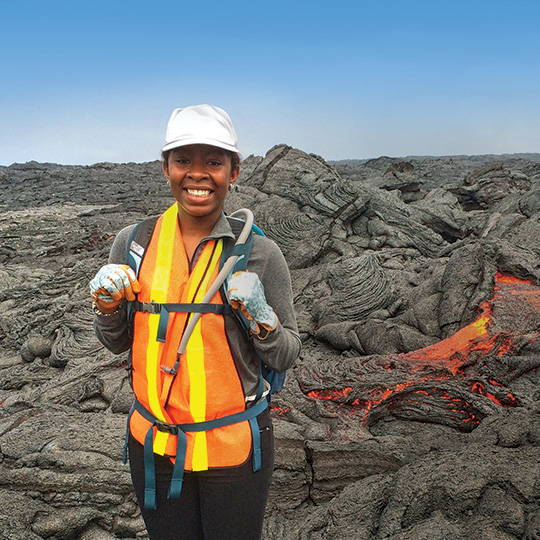 Imani Guest stands on volcanic rock.