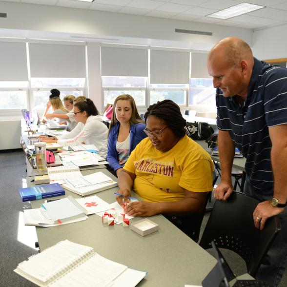 Faculty helping a student.