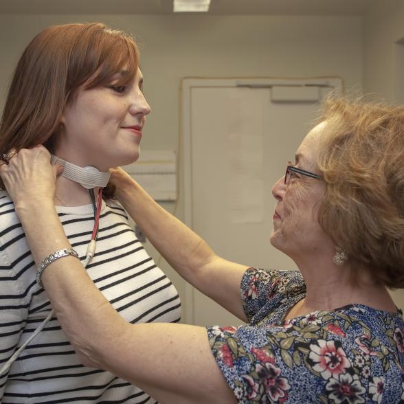 Student with a voice sensor being used by a faculty member