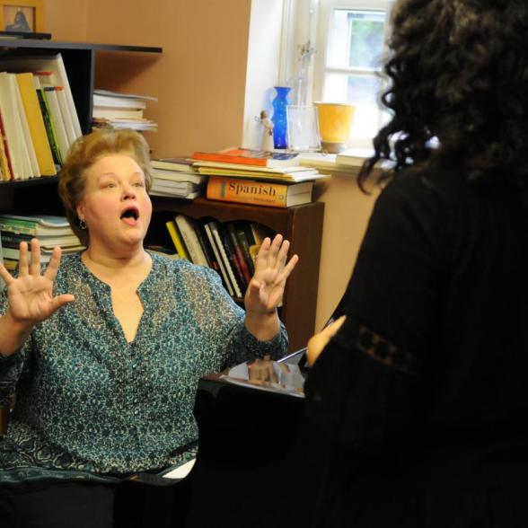 Faculty conducts student in a voice lesson
