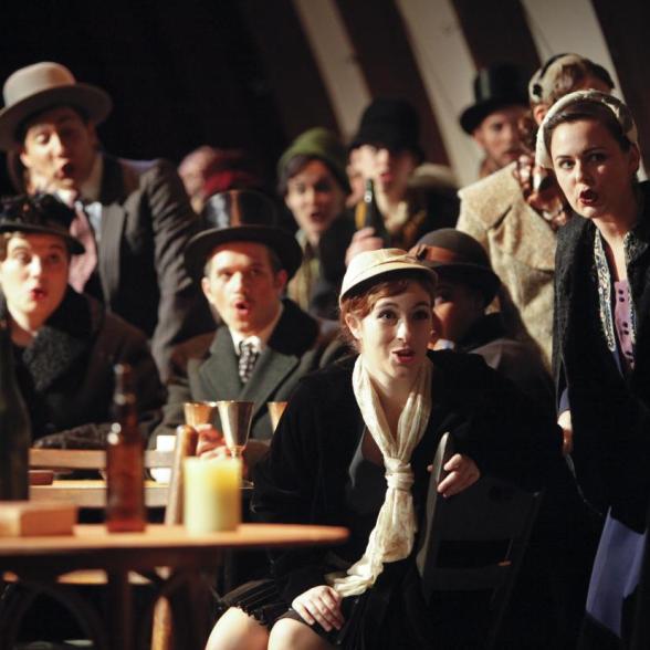 Students dressed in period clothing performing in a bar scene 